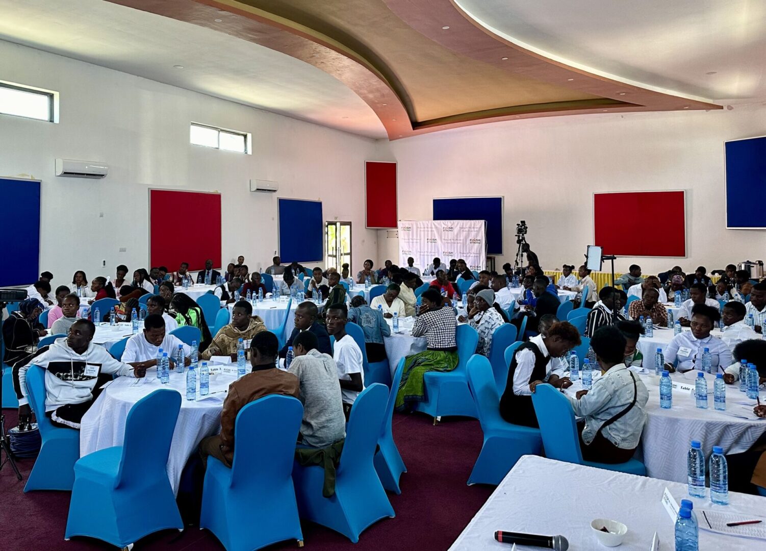 Conference attendees seated at round tables