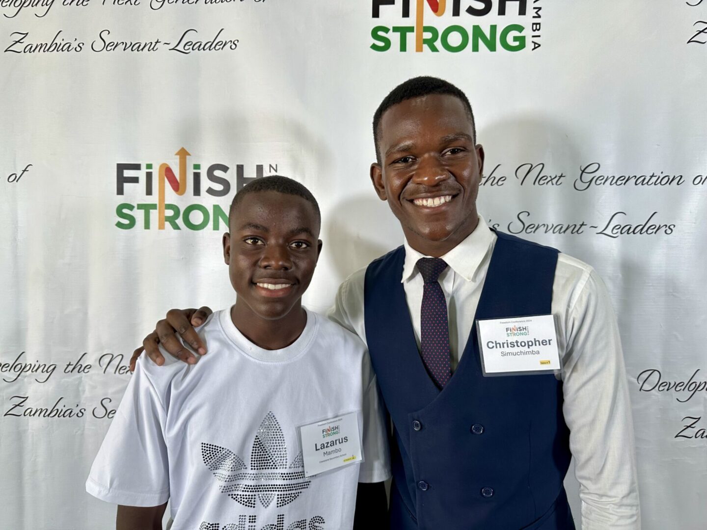 Smiling pair at Finish Strong backdrop