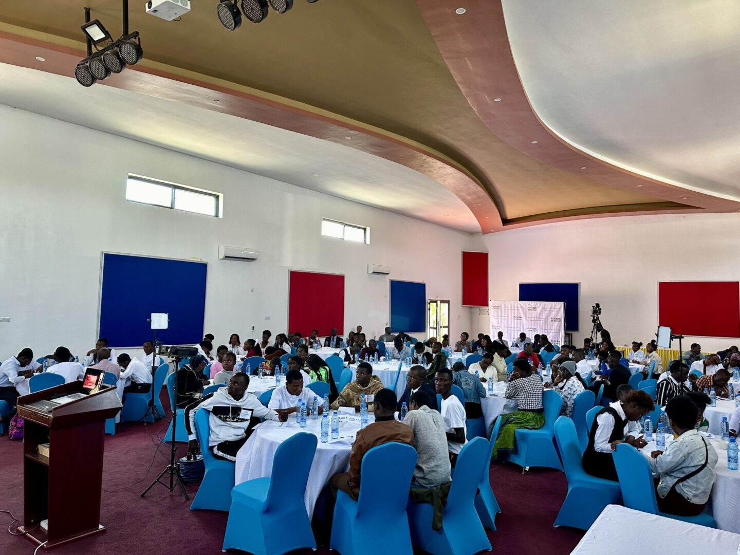 Conference room with attendees seated at tables.