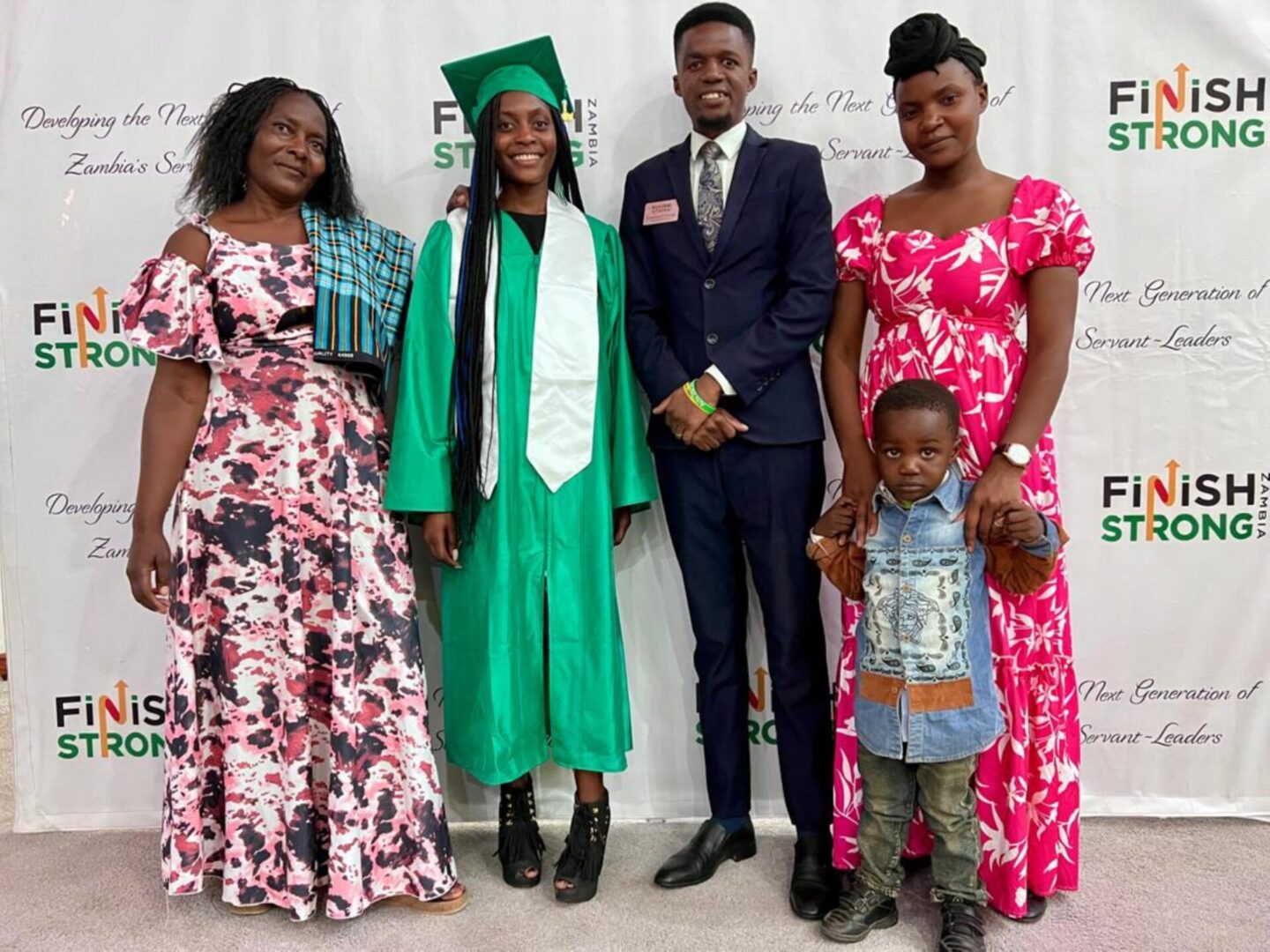 Graduate in green cap and gown
