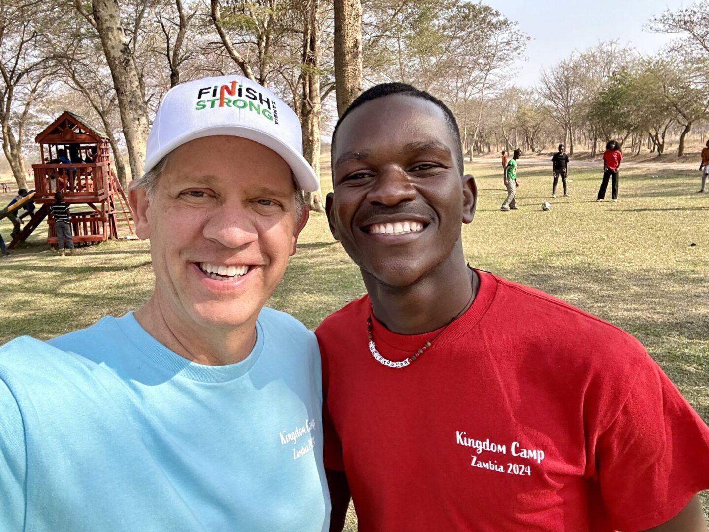 Two people smiling in a park