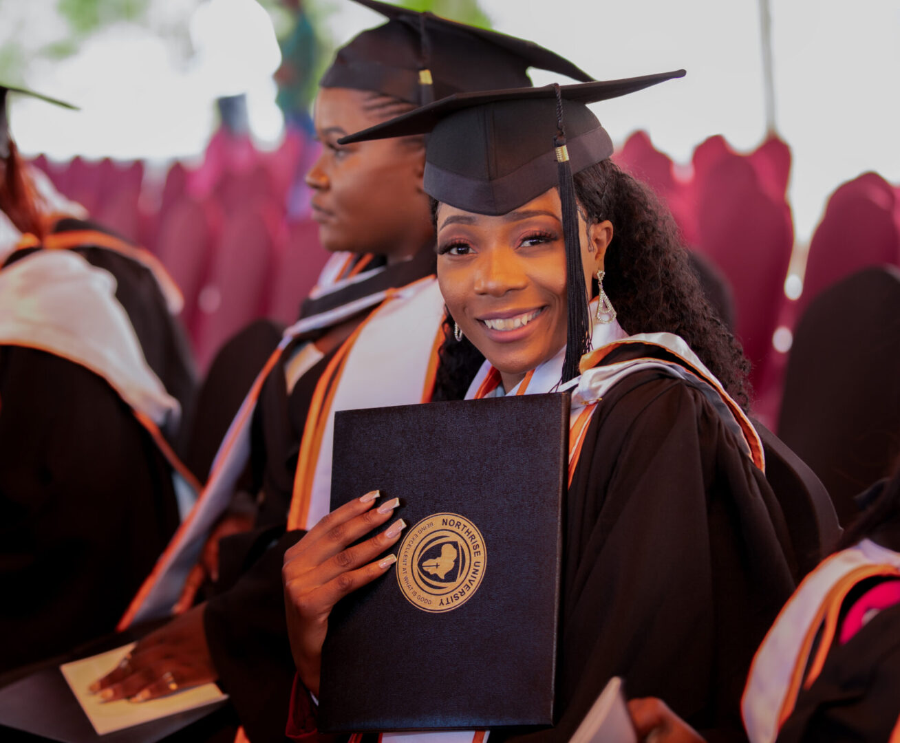 Student holding graduation certificate