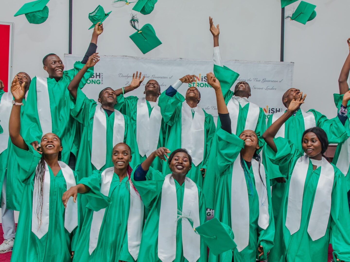 Students in green graduation gowns