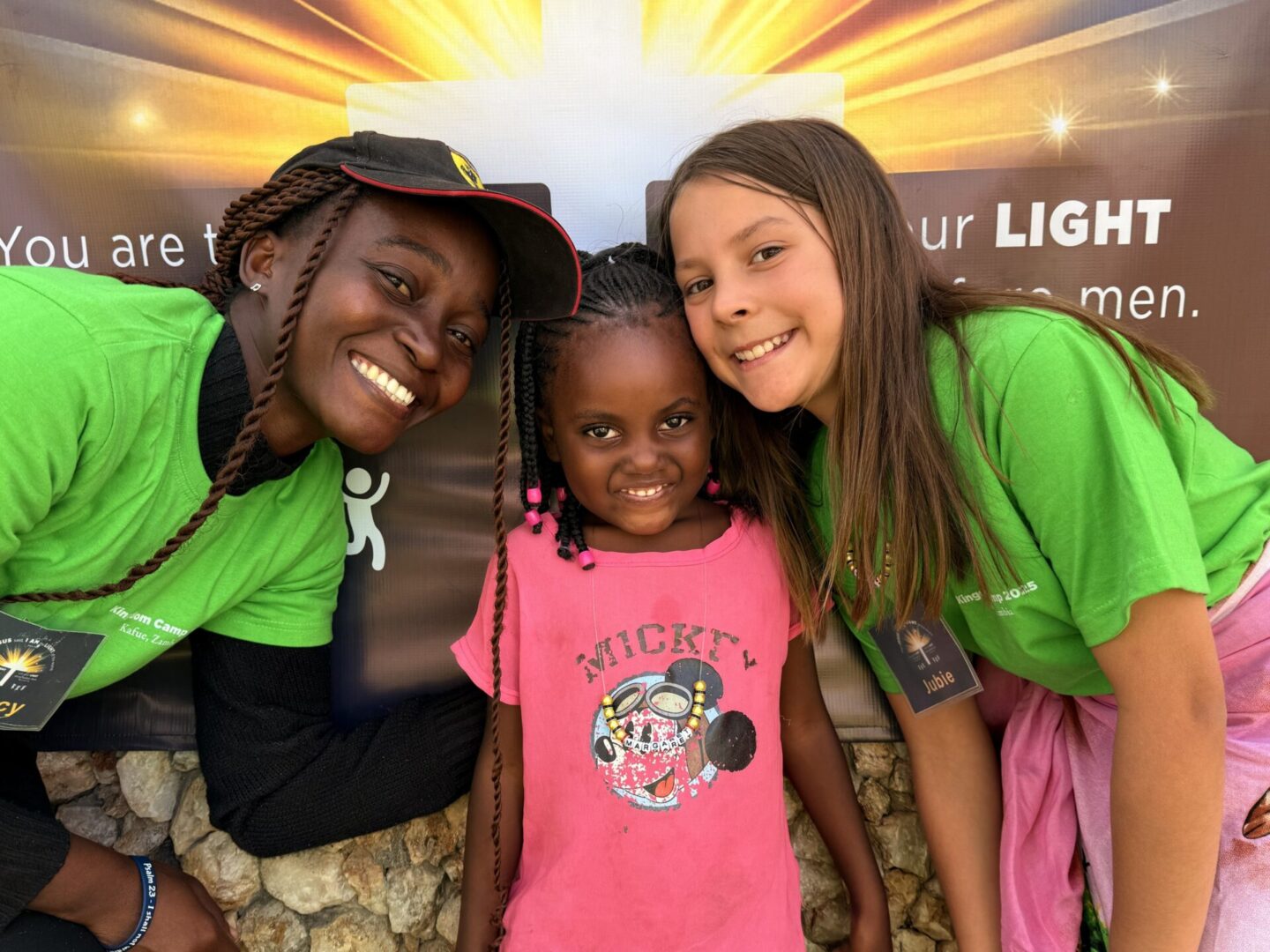 Three smiling girls posing together