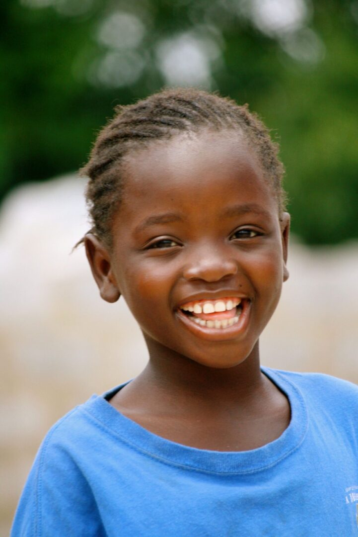 Happy child outdoors with braided hair